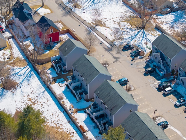 snowy aerial view featuring a residential view