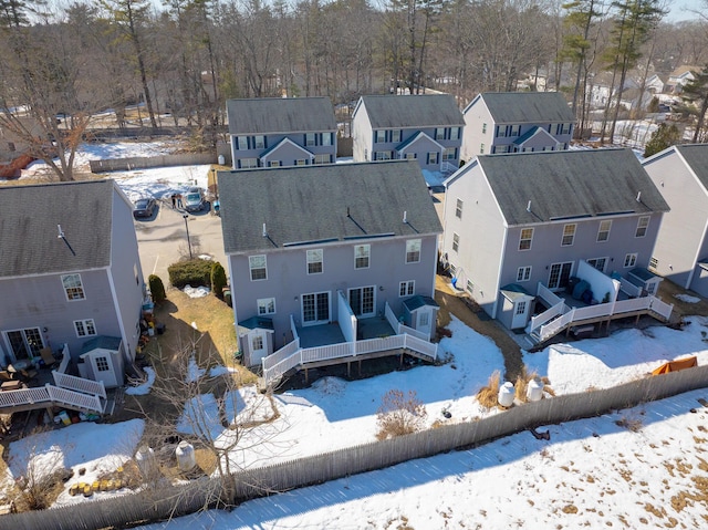 snowy aerial view featuring a residential view