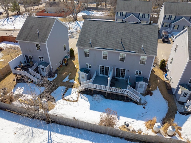 snowy aerial view with a residential view