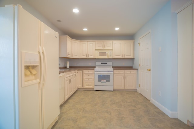 kitchen with recessed lighting, white appliances, and baseboards