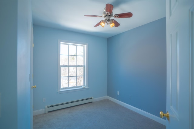 spare room with baseboards, a baseboard heating unit, a ceiling fan, and carpet