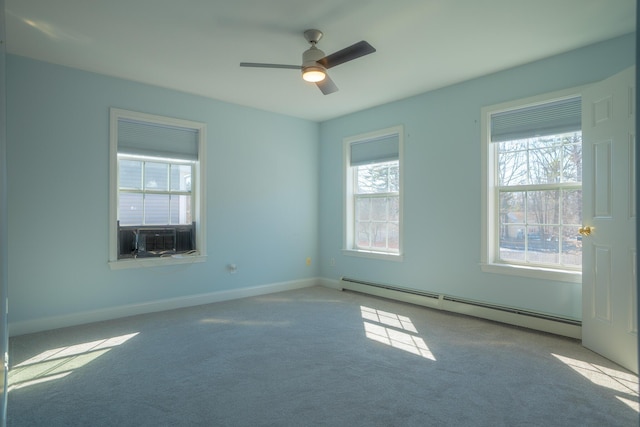 empty room featuring a baseboard heating unit, ceiling fan, baseboards, carpet flooring, and cooling unit