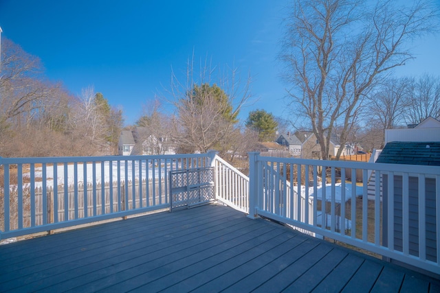 wooden deck featuring a residential view and fence