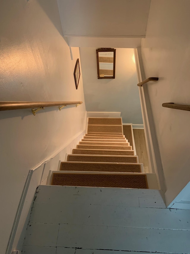 staircase with wood finished floors