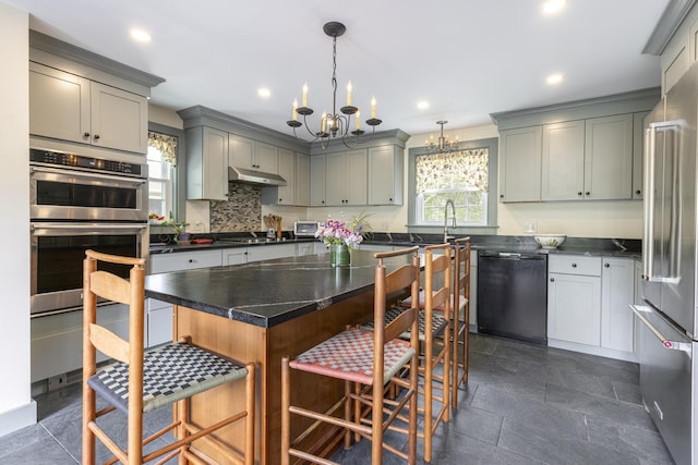 598 Walnut Hill Rd, North Yarmouth, ME 04097 - kitchen featuring appliances with stainless steel finishes, a chandelier, a kitchen bar, gray cabinets, and recessed lighting