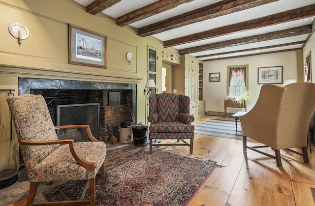 598 Walnut Hill Rd, North Yarmouth, ME 04097 - sitting room with a high end fireplace, light wood finished floors, and beam ceiling