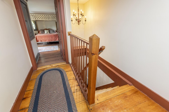 598 Walnut Hill Rd, North Yarmouth, ME 04097 - hall with an upstairs landing, a chandelier, wood finished floors, and baseboards