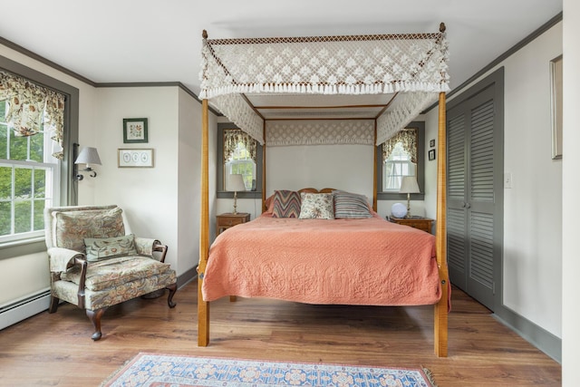 598 Walnut Hill Rd, North Yarmouth, ME 04097 - bedroom featuring ornamental molding, wood finished floors, a baseboard heating unit, and baseboards