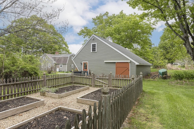 598 Walnut Hill Rd, North Yarmouth, ME 04097 - back of property with a garden, a chimney, and roof with shingles
