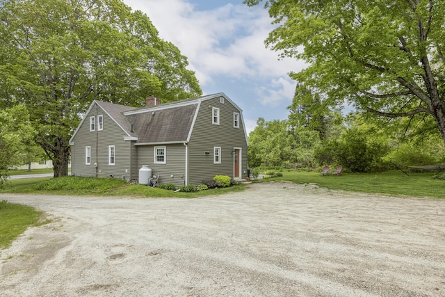 598 Walnut Hill Rd, North Yarmouth, ME 04097 - view of side of property with a shingled roof, a gambrel roof, a chimney, and driveway