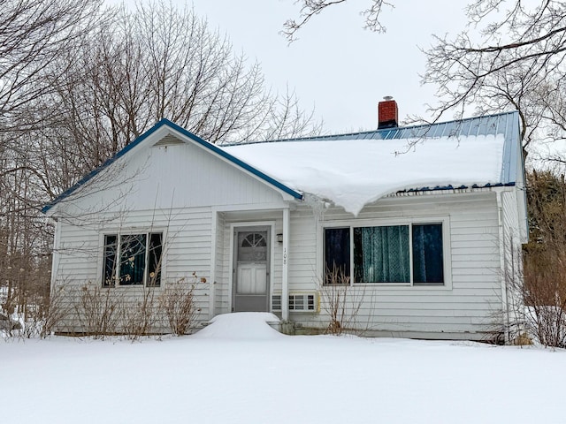 view of front facade featuring a chimney