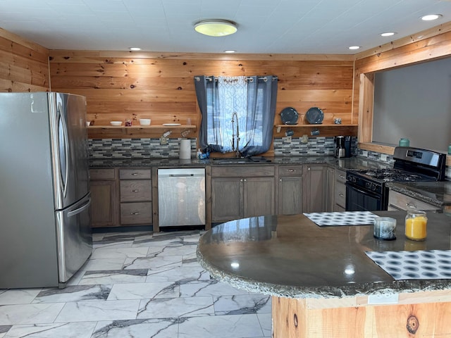 kitchen featuring marble finish floor, open shelves, tasteful backsplash, dark stone counters, and appliances with stainless steel finishes