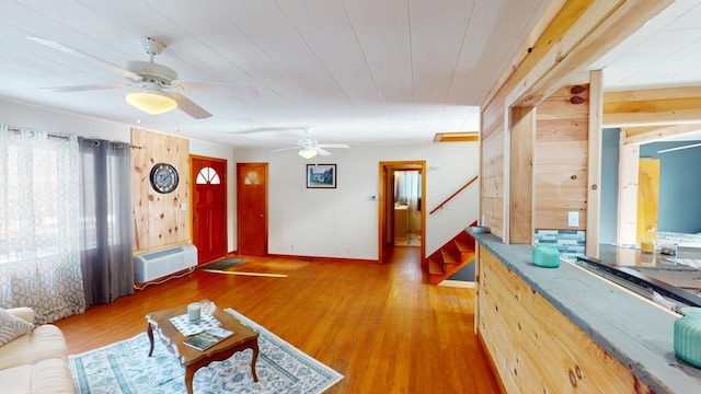 interior space featuring stairway, baseboards, and wood finished floors