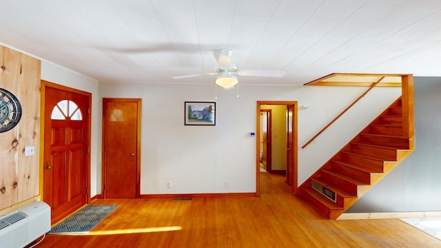 foyer entrance featuring visible vents, stairs, baseboards, and wood finished floors