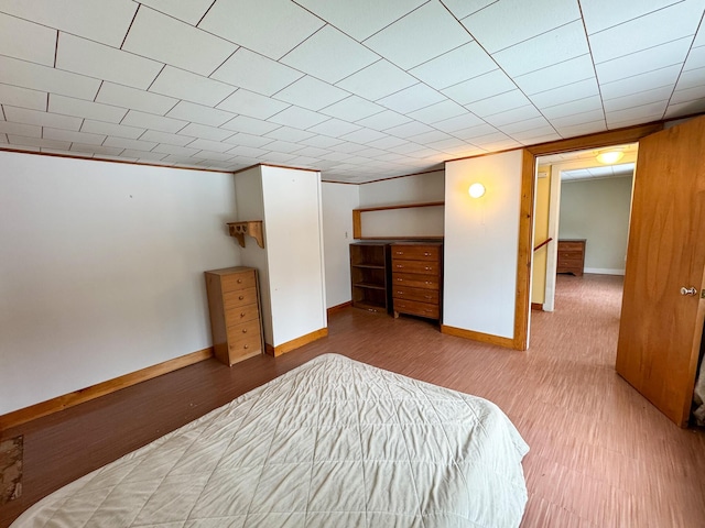 bedroom featuring baseboards and wood finished floors