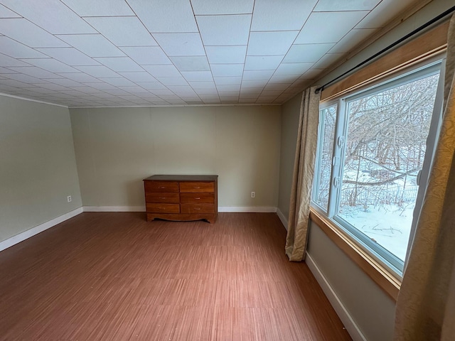 empty room with wood finished floors and baseboards