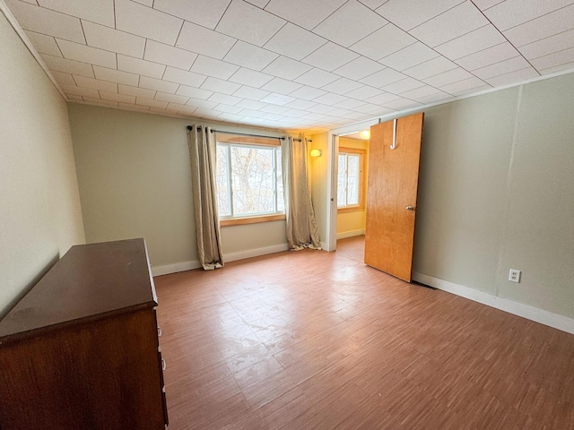 unfurnished room featuring baseboards and wood finished floors