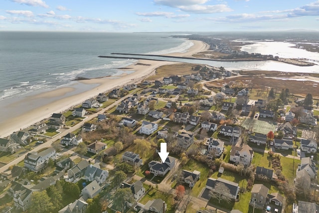 drone / aerial view featuring a residential view, a water view, and a beach view