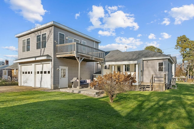 back of property with a garage, driveway, and a yard