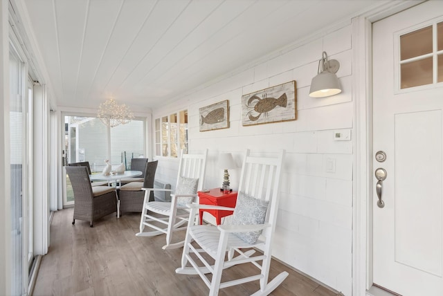 sunroom with wood ceiling and a chandelier