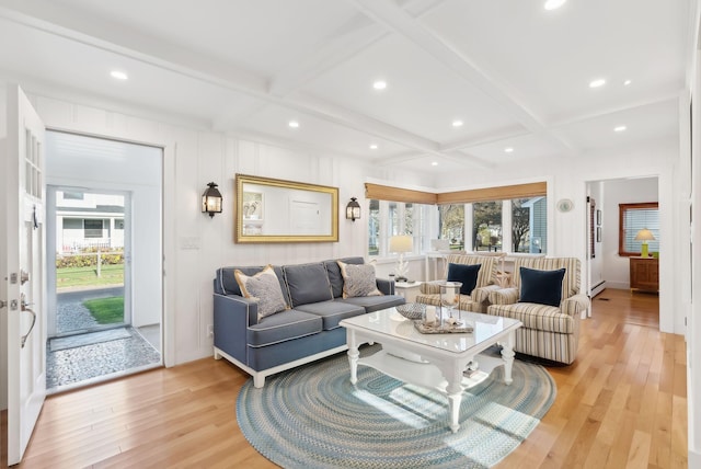 living area with light wood-style flooring, coffered ceiling, beamed ceiling, and a wealth of natural light