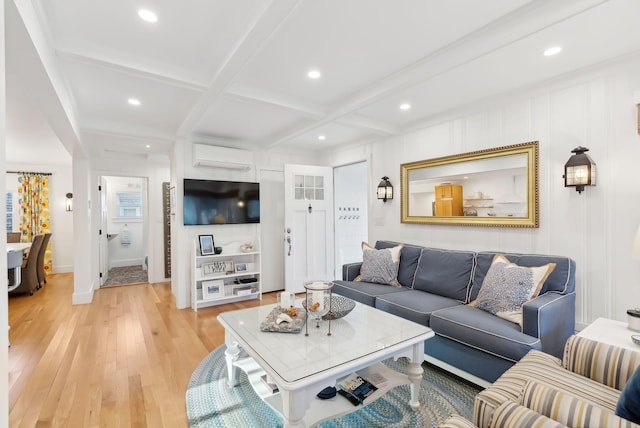 living room featuring coffered ceiling, light wood-style flooring, recessed lighting, an AC wall unit, and beamed ceiling