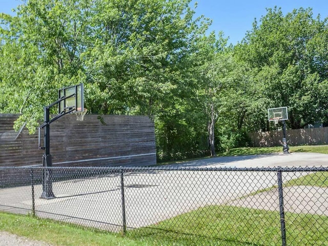 view of sport court featuring fence and basketball court