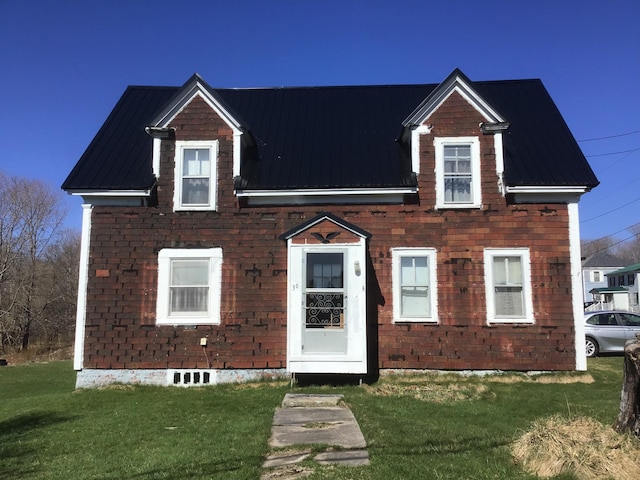 view of front facade with metal roof and a front lawn