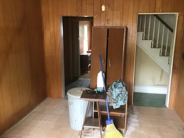 kitchen with wood walls and brown cabinets