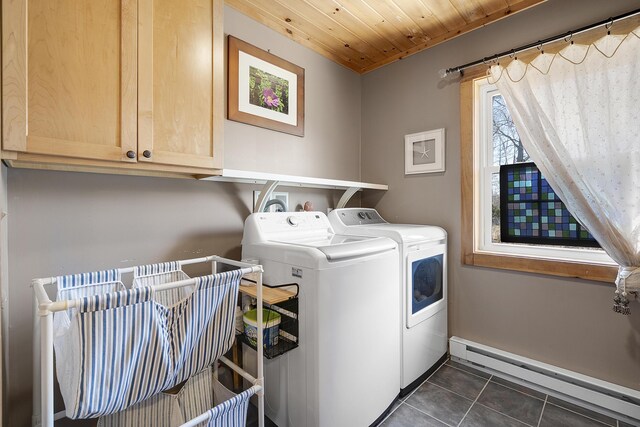 washroom with baseboard heating, wood ceiling, dark tile patterned flooring, cabinet space, and independent washer and dryer