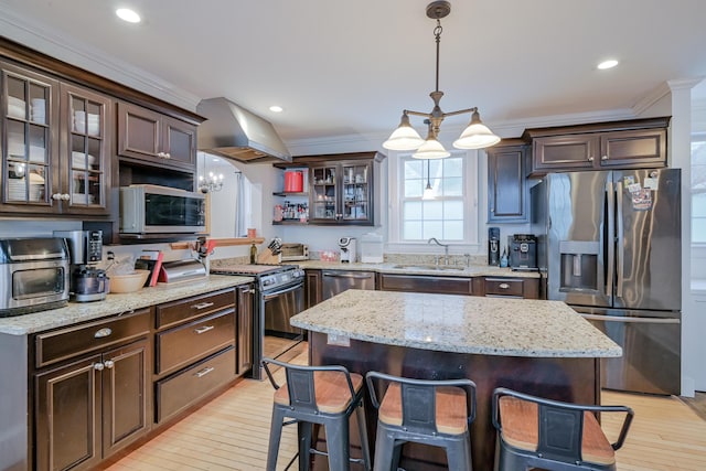 kitchen with a sink, stainless steel appliances, dark brown cabinets, and range hood