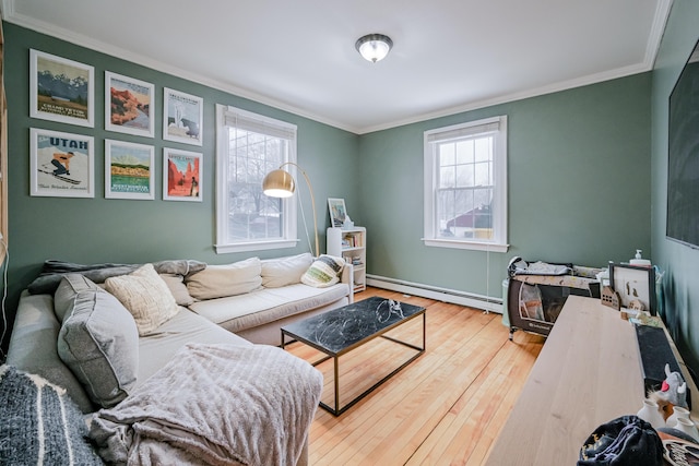 living room featuring a wealth of natural light, ornamental molding, hardwood / wood-style flooring, and a baseboard radiator