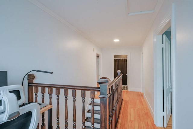 hallway featuring baseboards, ornamental molding, an upstairs landing, recessed lighting, and light wood-style floors