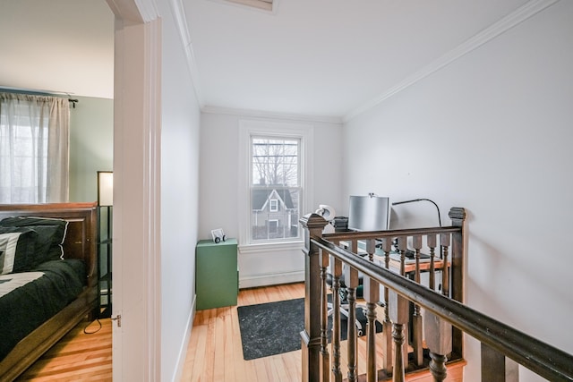 bedroom featuring crown molding, baseboards, and wood finished floors