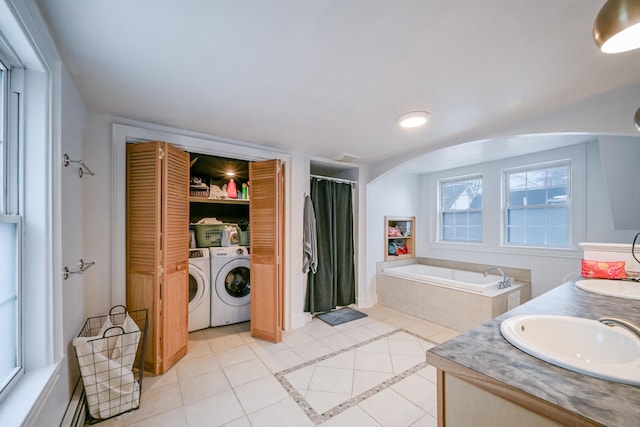 bathroom with tile patterned floors, a sink, washer and dryer, a shower with shower curtain, and a bath