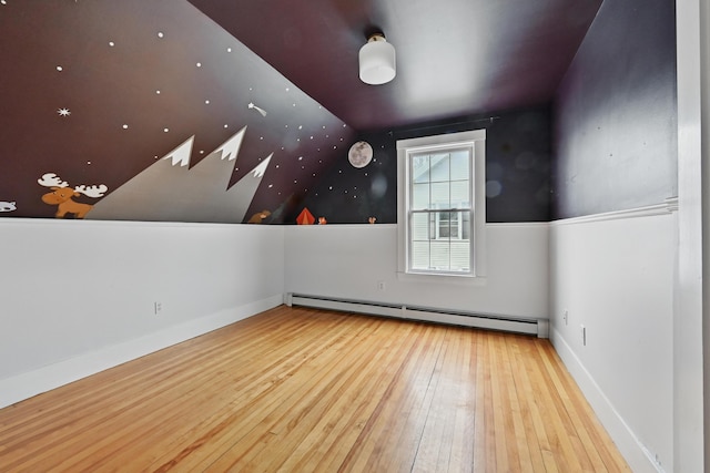 bonus room with vaulted ceiling, hardwood / wood-style floors, and a baseboard radiator