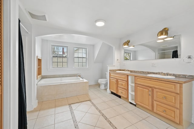bathroom featuring a sink, tile patterned floors, a wealth of natural light, and toilet
