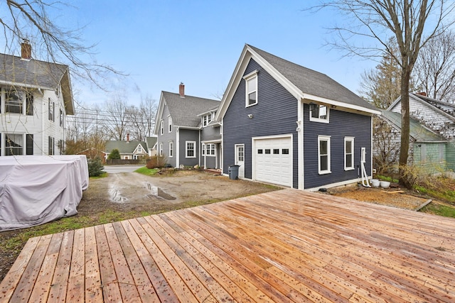 view of side of home with a garage and a wooden deck