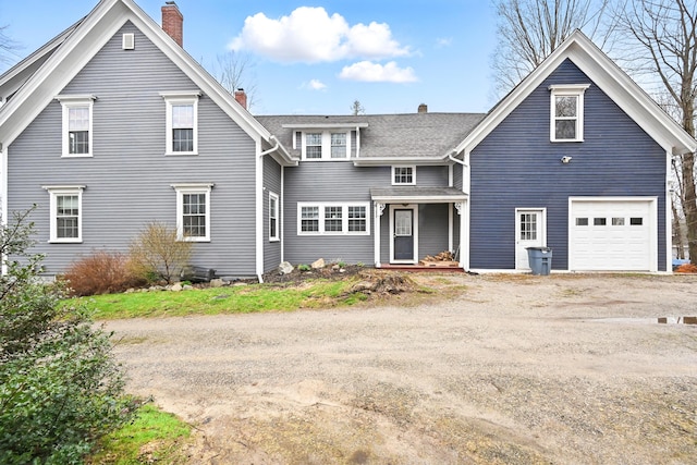 view of front of property with driveway and a chimney