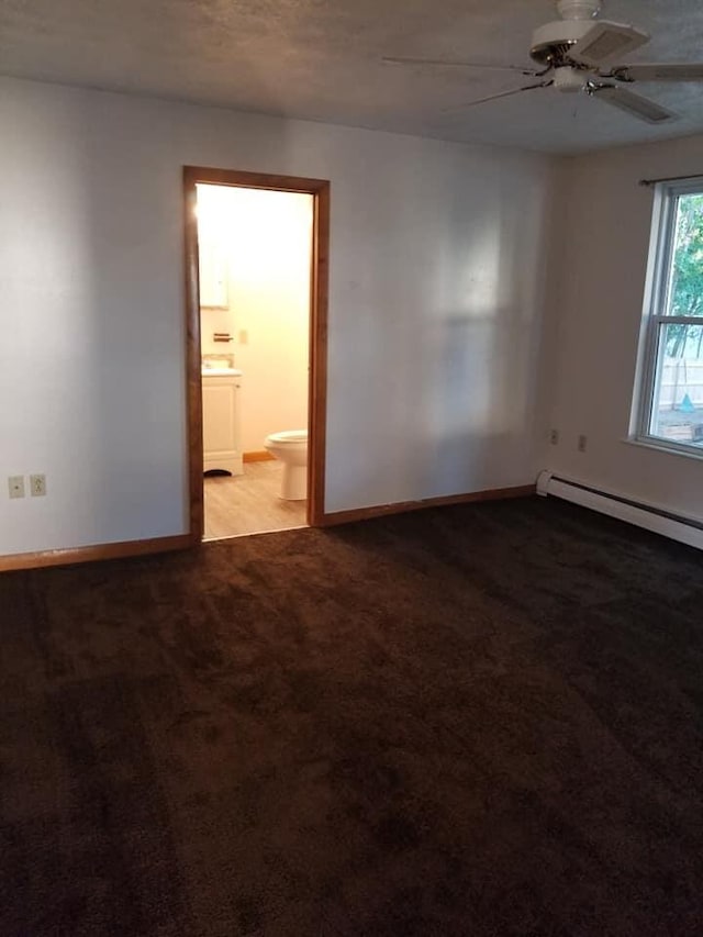 carpeted empty room with ceiling fan, a baseboard heating unit, and baseboards