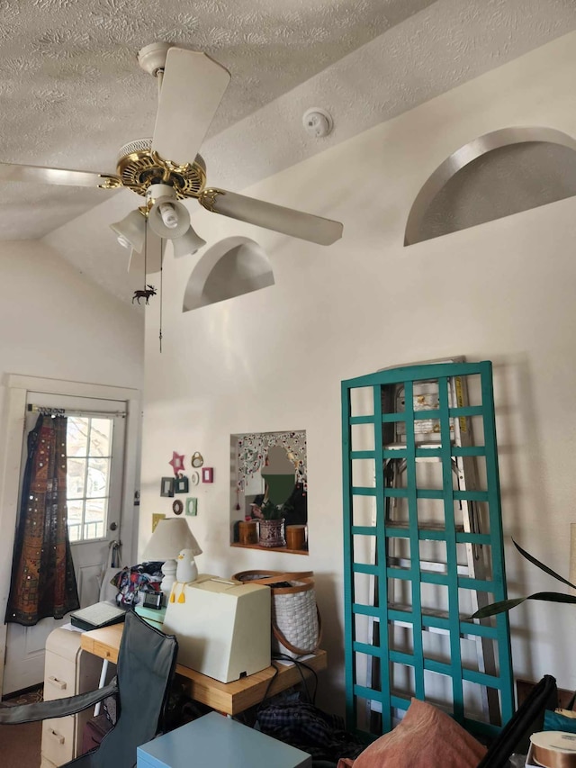 office space featuring a textured ceiling, ceiling fan, and vaulted ceiling