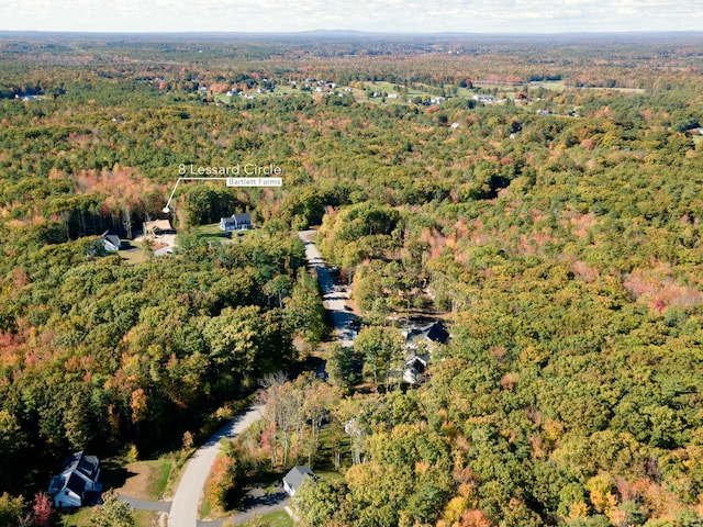 birds eye view of property featuring a wooded view