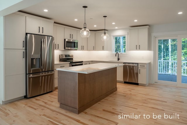 kitchen with tasteful backsplash, a center island, light wood-type flooring, stainless steel appliances, and a sink