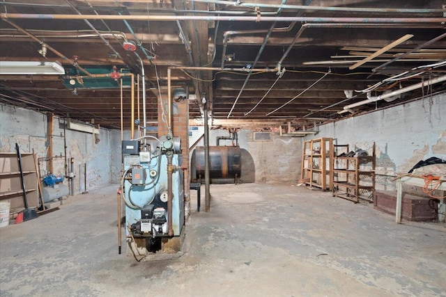 unfinished basement featuring heating fuel and a heating unit