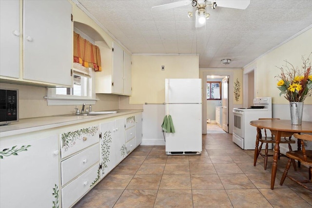 kitchen with white appliances, light tile patterned floors, a sink, light countertops, and crown molding