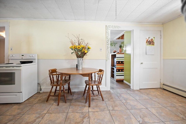 tiled dining room with baseboard heating and ornamental molding