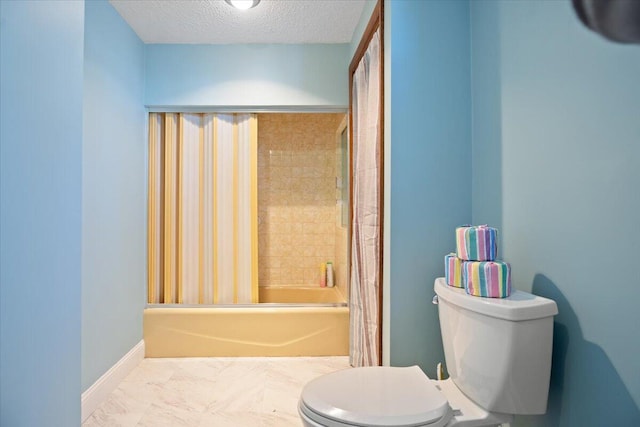 bathroom with shower / bath combo with shower curtain, toilet, marble finish floor, a textured ceiling, and baseboards