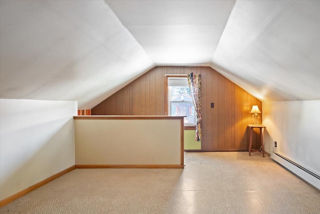 additional living space featuring a baseboard radiator, baseboards, and vaulted ceiling