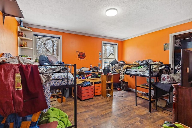 bedroom featuring a textured ceiling and wood finished floors