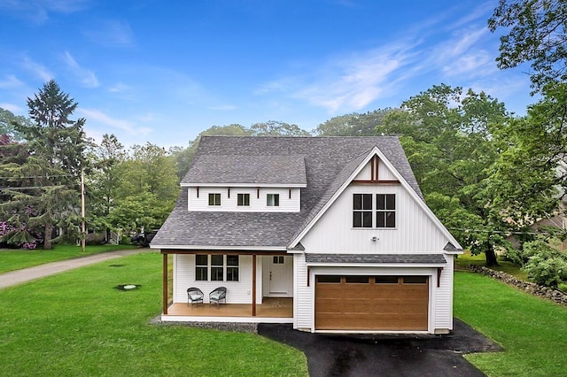 75 Main St, York, ME 03909 - modern inspired farmhouse featuring roof with shingles, covered porch, asphalt driveway, and a front yard